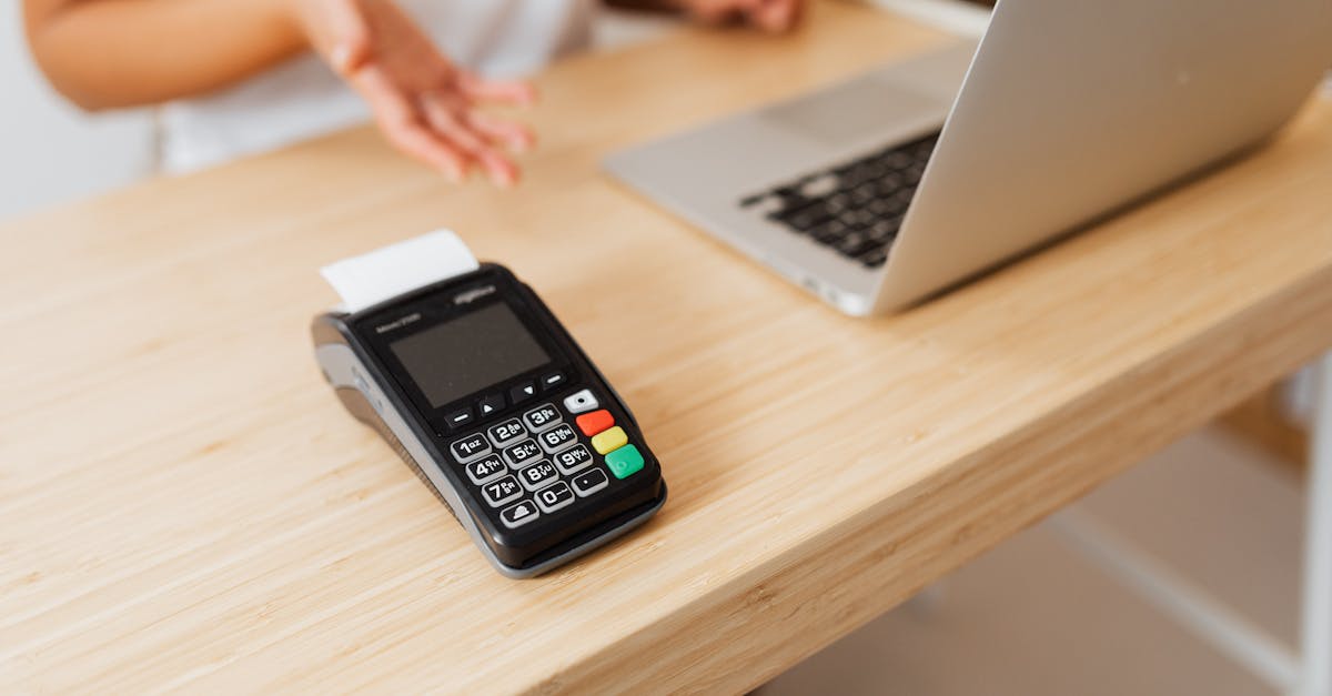 close up of a card reader on a wooden desk ready for contactless payment